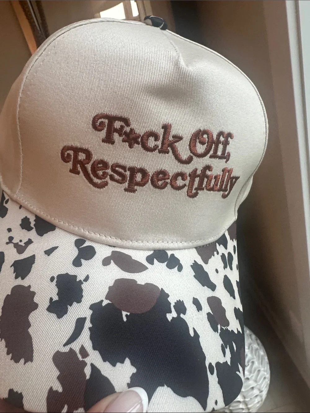 Cream Trucker Hat with Brown Cow Print and Embroidered Slogan